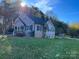 Gray house with stone accents, a deck, and a spacious yard at 4541 Hall Dairy Rd, Claremont, NC 28610