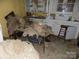 Kitchen with damaged cabinets and debris on floor at 523 Hoyle St, Dallas, NC 28034