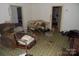 Living room with cluttered furniture and worn carpet at 523 Hoyle St, Dallas, NC 28034