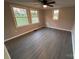 Bright bedroom featuring gray walls, wood-look flooring, and large windows at 701 Firecrest Se St, Concord, NC 28025