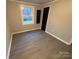 Simple bedroom with single window, new flooring and a closet at 701 Firecrest Se St, Concord, NC 28025