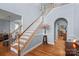 Elegant staircase with wood railings and hardwood floors at 10232 Squires Way, Cornelius, NC 28031