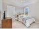 Well-lit bedroom with carpeted floor, queen bed, and window with natural light at 11325 Fullerton Place Nw Dr, Huntersville, NC 28078