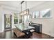 Modern dining room with a large table, bench seating, and plenty of natural light at 11325 Fullerton Place Nw Dr, Huntersville, NC 28078