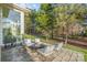 Relaxing patio with seating area, surrounded by trees and greenery at 11325 Fullerton Place Nw Dr, Huntersville, NC 28078