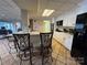 Basement kitchen with white cabinets, black appliances, and breakfast bar at 121 48Th Ne Ave, Hickory, NC 28601