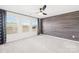 Bright bedroom with three windows, gray carpeting, and an accent wall at 12829 Robert Walker Dr, Davidson, NC 28036