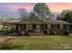 Brick ranch house with carport and landscaped yard at dusk at 1314 Frederick St, Shelby, NC 28150