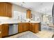 View of kitchen sink, dishwasher, and ample wood cabinetry at 1576 Nw Dartmoor Nw Ave # 1178, Concord, NC 28027