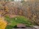 Aerial view showcasing a large backyard, wooden gazebo, and surrounding trees at 325 Fairfield Ct, Mount Gilead, NC 27306