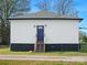 White house with a dark gray base and wooden steps leading to the entrance at 3338 York Hwy, Gastonia, NC 28052