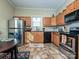 Functional kitchen with wood cabinets, stainless steel appliances, and tile flooring at 423 Park Ave, Pineville, NC 28134