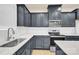 Modern kitchen with dark cabinetry, white countertops, and stainless steel appliances at 5532 Axil Ln, Charlotte, NC 28269