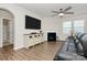 Cozy living room featuring a fireplace, hardwood floors, and a large TV at 913 Deep River Way, Waxhaw, NC 28173