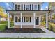 Charming front porch with white columns and a concrete walkway at 934 Log Cabin Dr, Gastonia, NC 28054