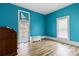 Bedroom with light wood floors and teal walls at 126 Charlotte St, York, SC 29745