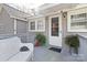 Home exterior with gray siding, white door, and small deck at 126 Charlotte St, York, SC 29745