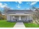 Charming gray house with a front porch and well-maintained lawn at 126 Charlotte St, York, SC 29745