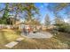 Spacious backyard with fire pit, shed, and wooden fence at 128 Hugh Caldwell Rd, Charlotte, NC 28214