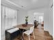 Bright dining area with wood table and white chairs, open to living area at 128 Hugh Caldwell Rd, Charlotte, NC 28214