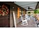 Inviting front porch with rocking chairs and a sunflower wreath at 13538 Pine Harbor Rd, Charlotte, NC 28278