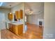 Kitchen with wood cabinets, view of living room with fireplace at 1776 Northgate Ln, Rock Hill, SC 29732