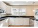 Bright kitchen with white cabinets, granite countertops, and stainless steel appliances at 2129 James Ct, Rock Hill, SC 29732