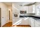 White kitchen cabinets, black countertops and stainless steel appliances at 2129 James Ct, Rock Hill, SC 29732
