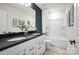 Modern bathroom with double vanity, dark countertop, and a bathtub at 5137 Hales Ford Rd # 39, Charlotte, NC 28215