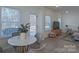 Bright dining area with a round table and four chairs, near sliding doors at 5971 Trinity Crossing Cir, Kannapolis, NC 28081