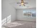 Bright bedroom featuring a ceiling fan and neutral carpeting at 6073 Cougar Ln, Charlotte, NC 28269