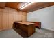 Basement office with wood-paneled walls and desks at 608 Hanover Dr, Shelby, NC 28150