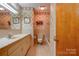 Bathroom with beige tile, vanity with sink, and tub at 608 Hanover Dr, Shelby, NC 28150