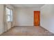 Simple bedroom with wood door and window with curtains at 608 Hanover Dr, Shelby, NC 28150