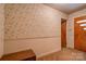 Entryway with floral wallpaper, wood-paneled door, and storage bench at 608 Hanover Dr, Shelby, NC 28150