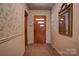 Entryway with floral wallpaper, wood-paneled door, and a mirror at 608 Hanover Dr, Shelby, NC 28150