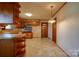 Kitchen offers wood cabinets, a tiled floor, and a unique light fixture at 608 Hanover Dr, Shelby, NC 28150