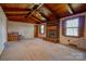 Living room features a brick fireplace, wood ceiling beams, and large windows at 608 Hanover Dr, Shelby, NC 28150