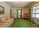 Living room with green carpeting, orange chair, and floral sofa at 608 Hanover Dr, Shelby, NC 28150