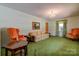 Living room with green carpet, orange chairs, and a floral sofa at 608 Hanover Dr, Shelby, NC 28150
