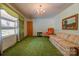 Living room with green carpet, orange armchair, and floral sofa at 608 Hanover Dr, Shelby, NC 28150