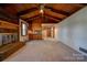 Open living room and kitchen area with wood ceilings and brick fireplace at 608 Hanover Dr, Shelby, NC 28150