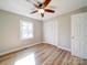 Bedroom with ceiling fan, wood-look floors, and a window at 6515 Deep Springs Rd, Marshville, NC 28103