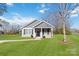 Gray house with white trim and black shutters.Features a covered porch and grassy lawn at 710 W Alabama Ave, Bessemer City, NC 28016