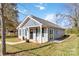 Gray house with white trim, black shutters, covered porch, and sliding glass door at 710 W Alabama Ave, Bessemer City, NC 28016