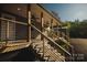 Covered porch with wooden stairs and metal railing at 115 Joels Hill Ln, Mooresville, NC 28117