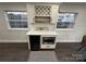 Built-in bar area with wine fridge, microwave, and quartz countertop at 151 Dogwood Cir, New London, NC 28127