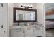 Double vanity bathroom with granite countertop and large mirror at 18912 Peninsula Point Dr, Cornelius, NC 28031