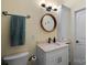 Clean bathroom with a vanity and a round mirror at 18912 Peninsula Point Dr, Cornelius, NC 28031