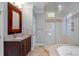 Bathroom with double vanity, large mirror, and walk-in shower at 18912 Peninsula Point Dr, Cornelius, NC 28031